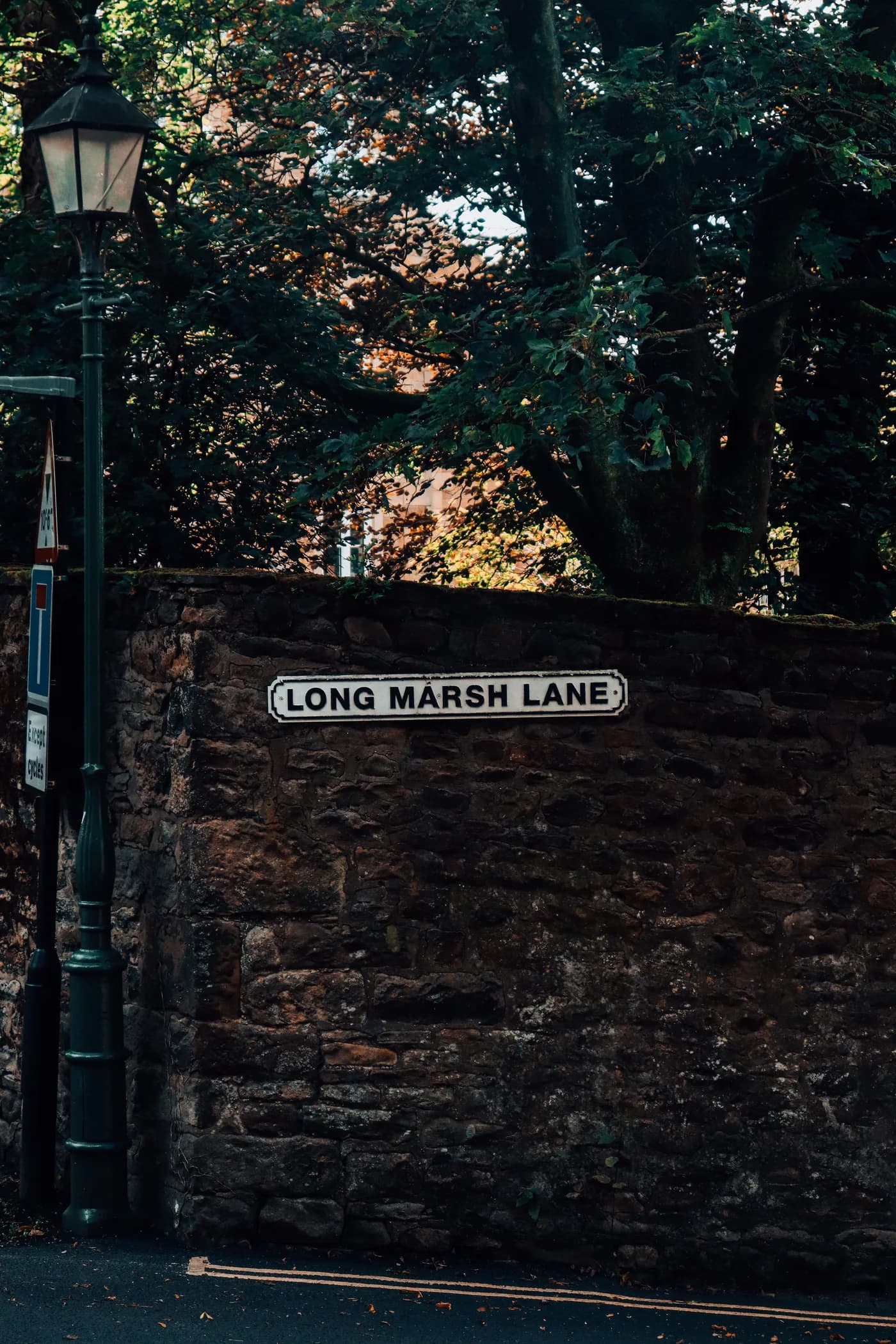 Long Marsh Lane street sign on a stone wall